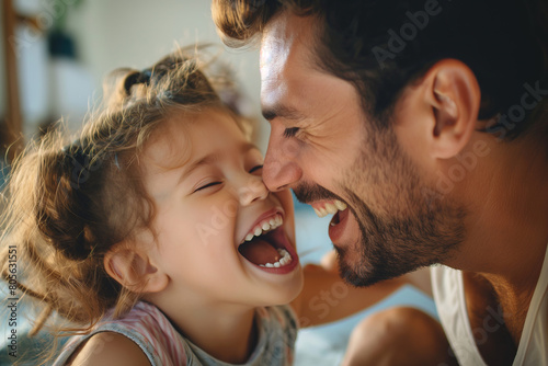 Father and Young Daughter Sharing a Joyful Laugh Together at Home