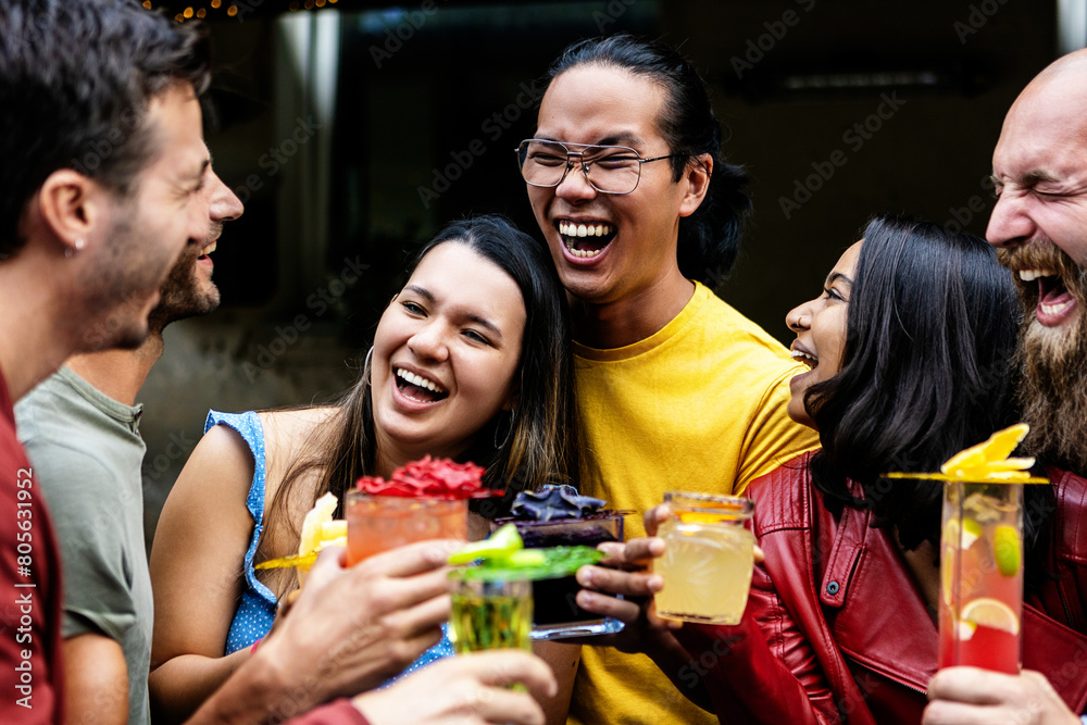 Young group of friends enjoying cocktail drink during happy hours at bar during summer vacation. Young group of friends enjoying cocktail drink during happy hours at bar during summer vacation.