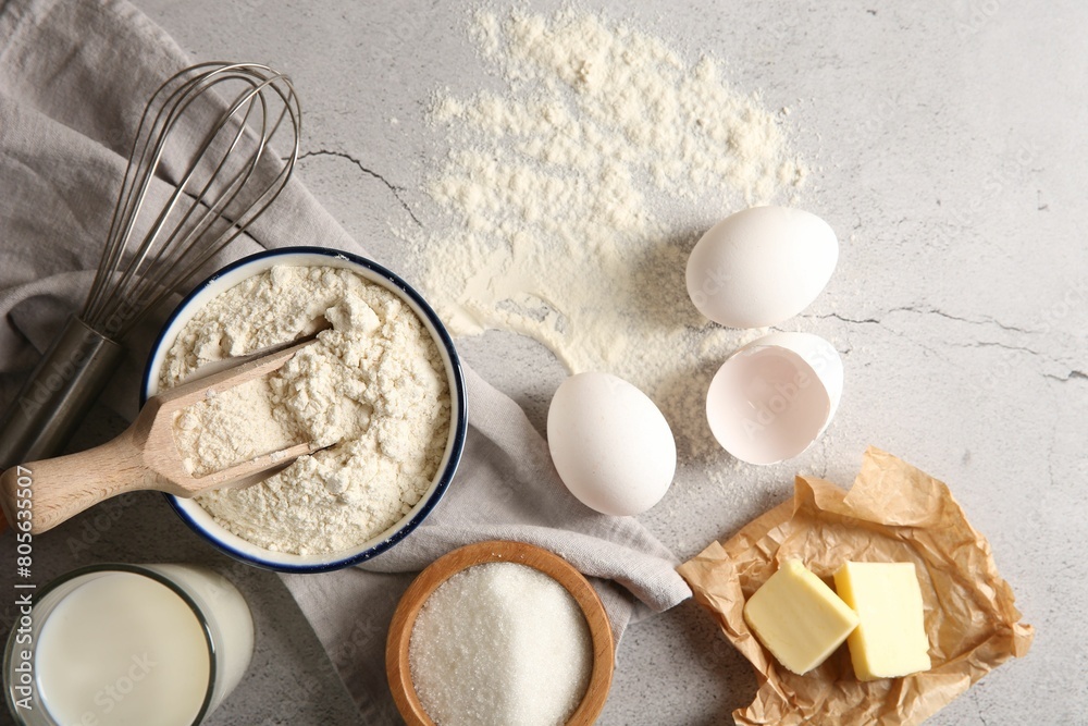 Different ingredients for dough and whisk on light textured table, flat lay Different ingredients for dough and whisk on light textured table, flat lay