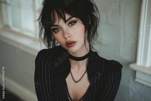 Portrait of a beautiful goth woman with black hair, green eyes and red lipstick. photo