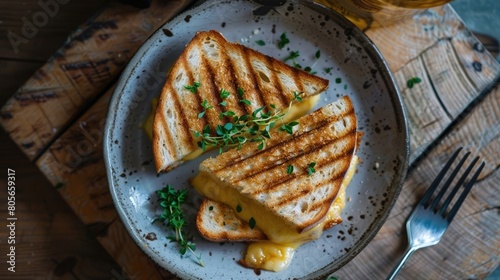 Half-eaten toastie on a plate, melted cheese stretching © Manzoor