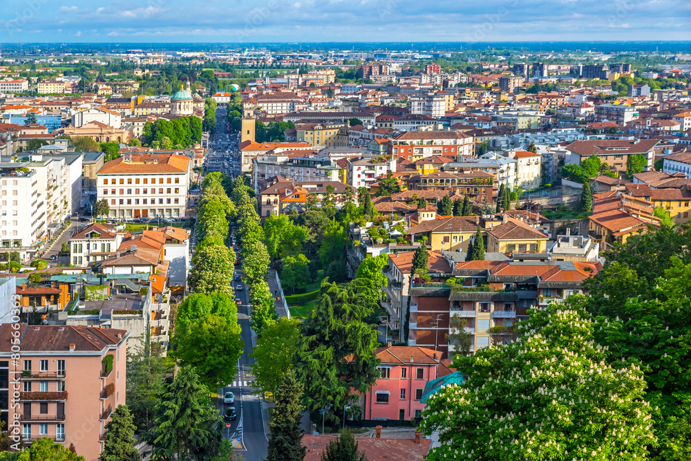 Aerial view of Bergamo city, Lombardy province, Italy. Picturesque skyline panorama of Bergamo main street, Viale Vittorio Emanuele II. Bergamo railway station on background