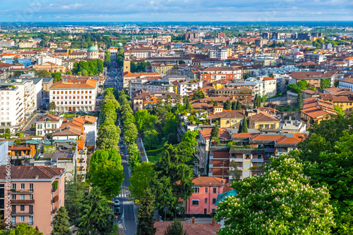 Aerial view of Bergamo city, Lombardy province, Italy. Picturesque skyline panorama of Bergamo main street, Viale Vittorio Emanuele II. Bergamo railway station on background photo