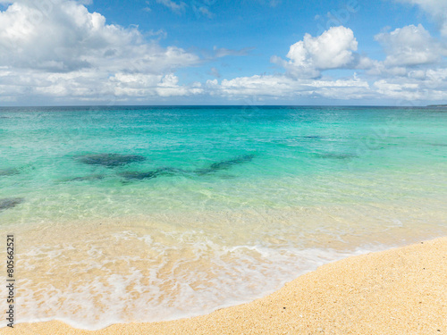 Beautiful inshore waves crashing on sands. Crystal clear waters. Blue sky and clouds. Puka Beach. Boracay, Philippines.