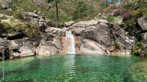 The Poço Azul (Blue Well) is an idyllic lagoon with crystal-clear water that comes from the Landeira stream, which flows through granitic rocks to create a waterfall in the Peneda-Gerês National Park.