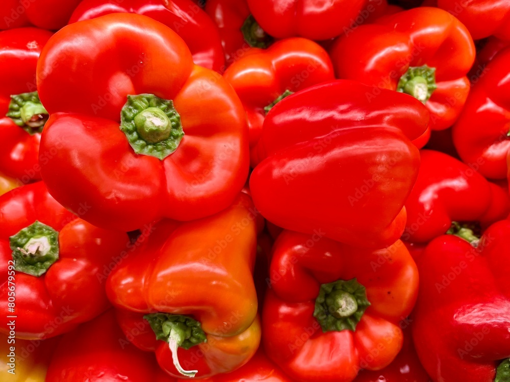 close-up of fresh red peppers stacked on an organic producer's display
