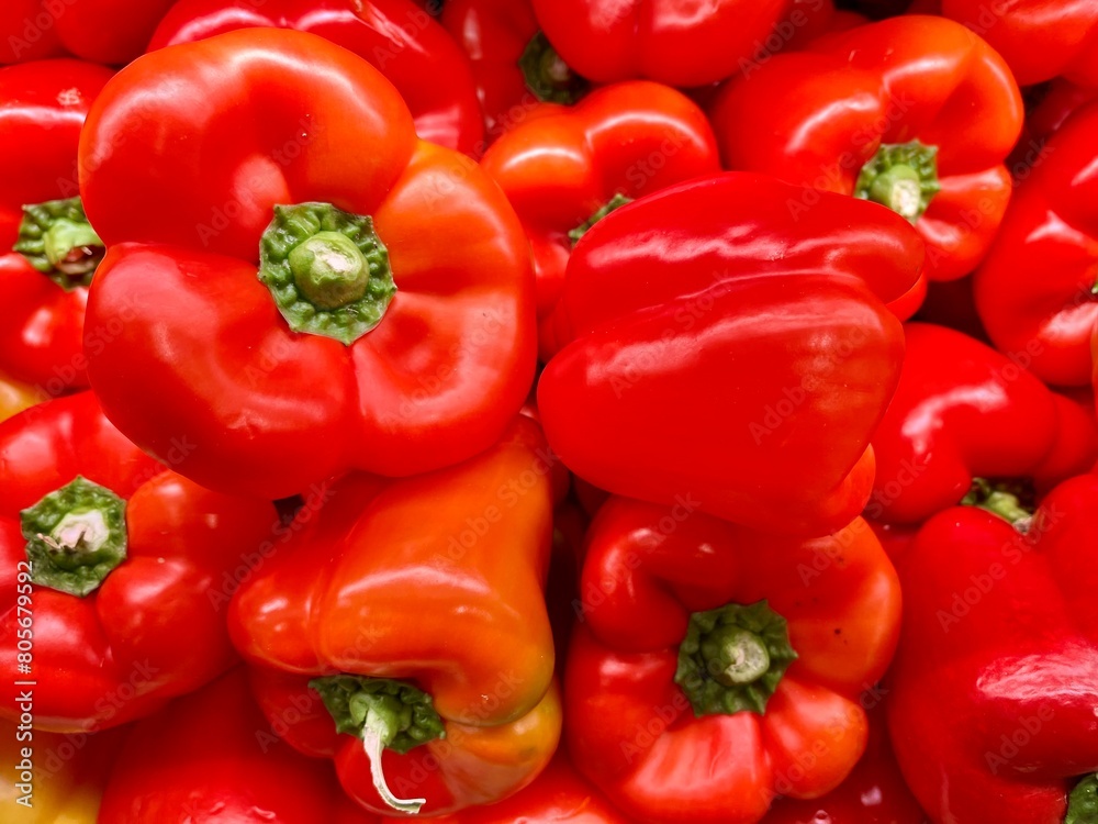 close-up of fresh red peppers stacked on an organic producer's display
close-up of fresh red peppers stacked on an organic producer's display