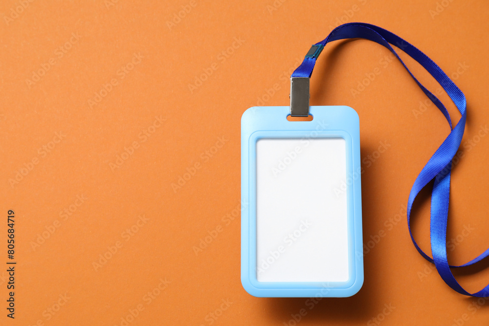Blank badge with string on orange background, top view. Space for text Blank badge with string on orange background, top view. Space for text