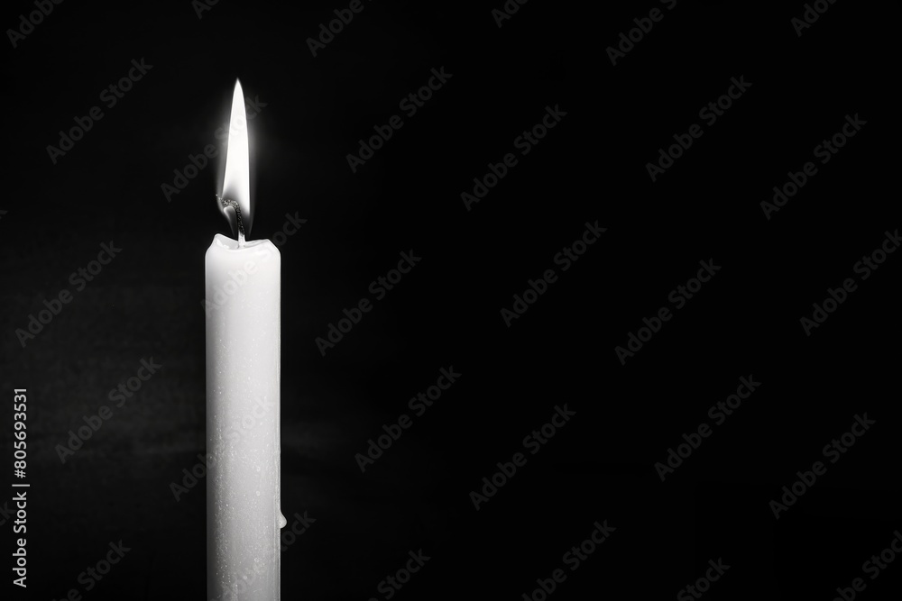 Burning candle on a dark background Burning candle on a dark background
