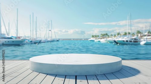 A large white pedestal sits on a wooden pier overlooking a marina full of boats