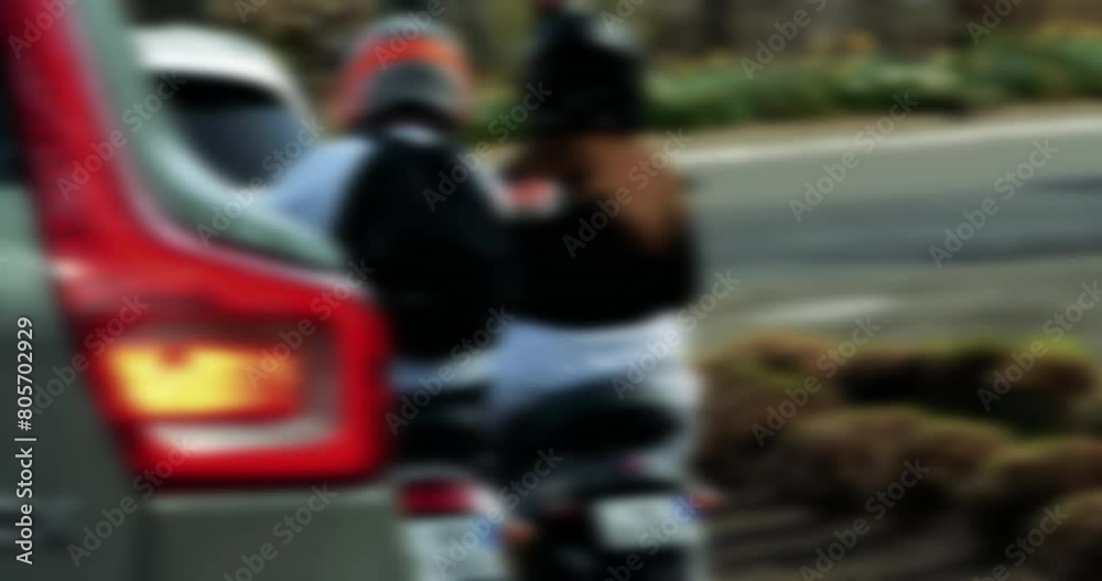 Rear View of Young Moped Riders at Red Light Rear View of Young Moped Riders at Red Light