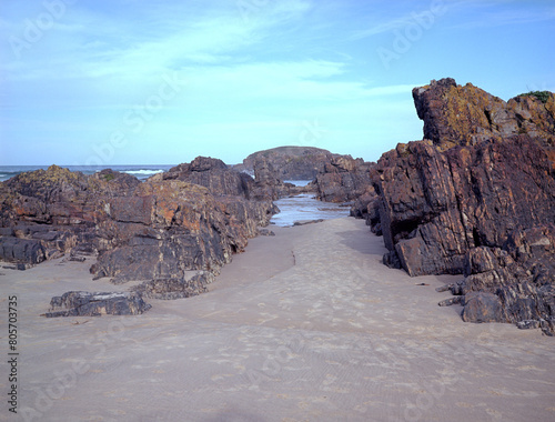 Sandy gap between the rocks on the beach. Medium format film (Kodak Ektar 100) shot scan (6x4.5 cm).