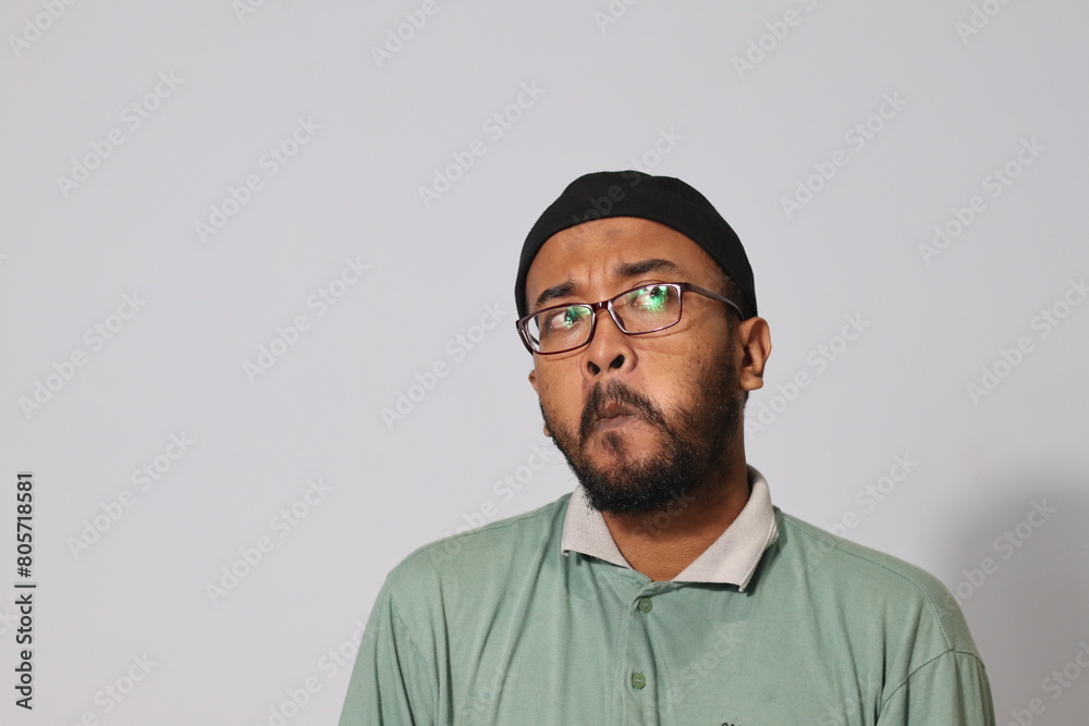 asian man wearing miki hat and glasses with thinking expression asian man wearing miki hat and glasses with thinking expression