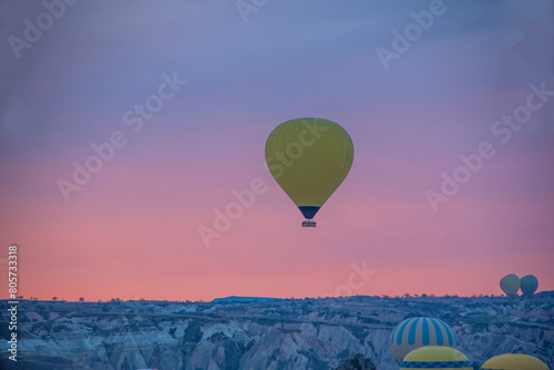 Sunrise in Cappadocia with colorful hot air balloons fly in sky over canyons  valleys morning tourist destination. Travel Turkey concept 