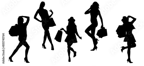 Silhouette of slim young woman carrying shopping bags.