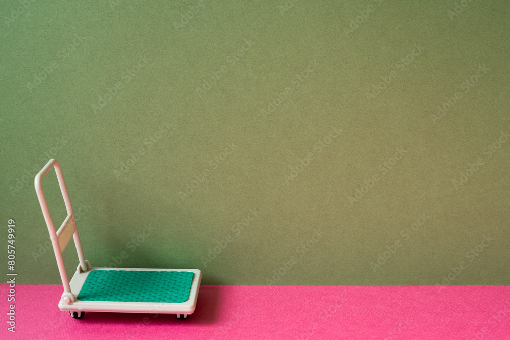Warehouse tool trolley cart on pink and khaki green background