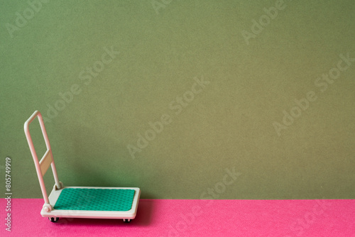 Warehouse tool trolley cart on pink and khaki green background