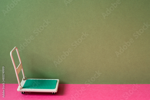 Obraz na płótnie Warehouse tool trolley cart on pink and khaki green background w salonie