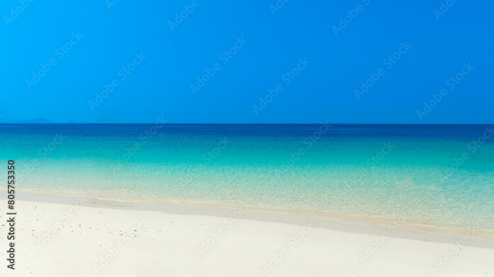 Nature of the beach and sea Summer with sunshine, sandy beaches, clear blue waters sparkling against the blue sky. On an island with good ecology and environment Background for summer vacation