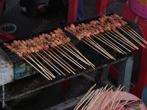 Chicken skewer. Sate Madura or Indonesian Chicken Satay are grilled on the fire. Maduranese Chicken Satay. photo