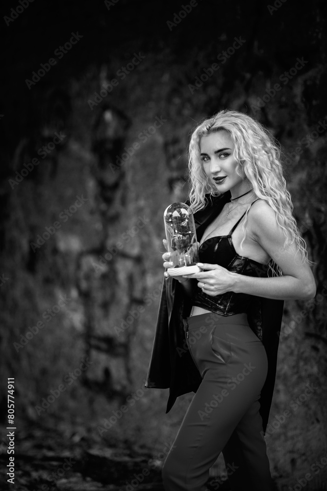 Obraz premium Portrait of a young beautiful blonde girl outdoors. Black and white photo.