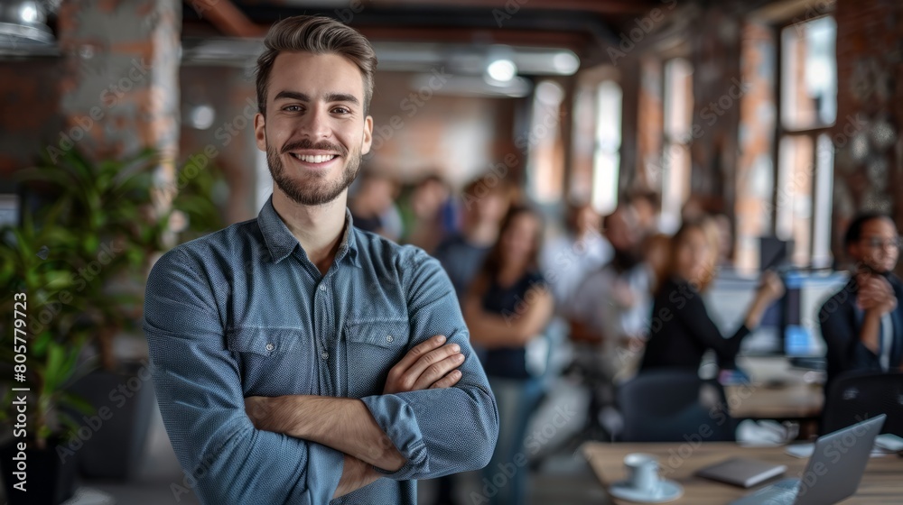 Fototapeta premium Smiling, happy and proud young business man with arms crossed showing great leadership to his team in an office. Portrait of a confident entrepreneur satisfied with new opportunity in a startup