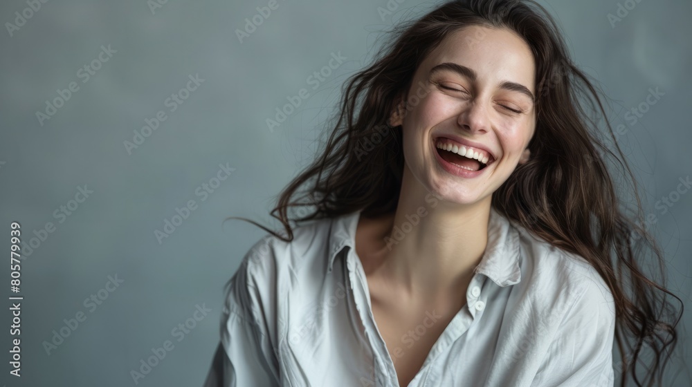 Studio portrait of attractive woman wearing shirt and laughing while sitting at isolated grey background. hyper realistic Studio portrait of attractive woman wearing shirt and laughing while sitting at isolated grey background. hyper realistic