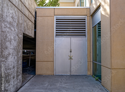 Metallic doors next to the parking garage of a modern office building