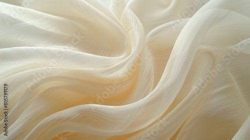  A tight shot of a white fabric with an extensively flowing one below it