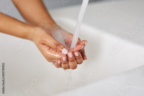 Hands  water and tap for cleaning  sink and bathroom in closeup  wash and home. Person  wellness and splash for healthy skincare  disinfection and safety from germs  bacteria or virus prevention