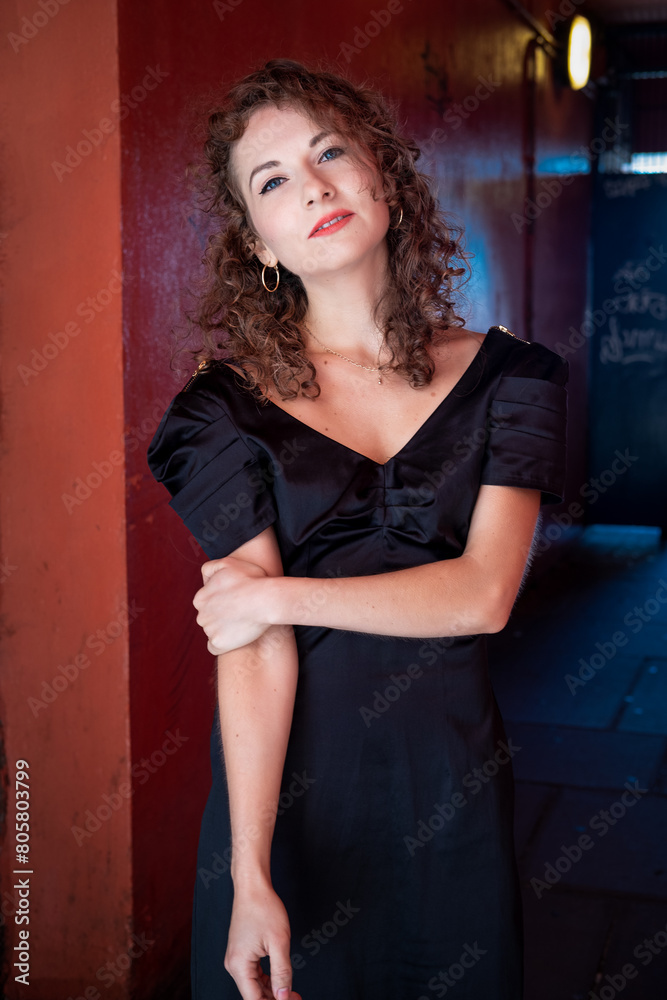 Relaxed caucasian woman looking at camera in corridor. Relaxed caucasian woman looking at camera in corridor.