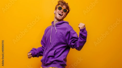 Man Celebrating in Purple Hoodie