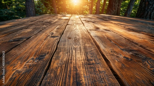   A tight shot of a sunlit wooden table  sun rays filtering through trees beyond