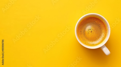  Overhead view of a steaming cup of coffee against a bright yellow background Lower portion empty for text or logo insertion