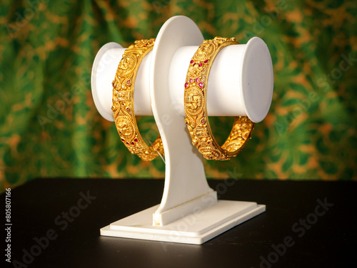 Traditional Indian design gold bangle. Fancy designer antique golden Bangles also known as "sone ka Kada" or "sone ka kangan". Indian Temple jewellery exclusive collection with gemstones.