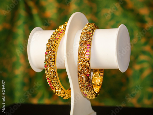 Traditional Indian design gold bangle. Fancy designer antique golden Bangles also known as "sone ka Kada" or "sone ka kangan". Indian Temple jewellery exclusive collection with gemstones.