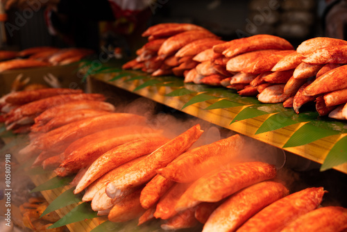 Fresh steaming crab legs arranged neatly on banana leaves showcasing the delicious offering at a vibrant seafood market