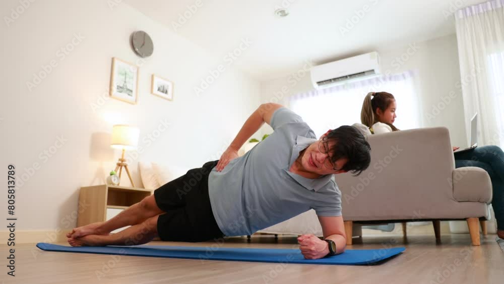 wellness at home. Handsome young man working out at home in bed room. wellness at home. Handsome young man working out at home in bed room.