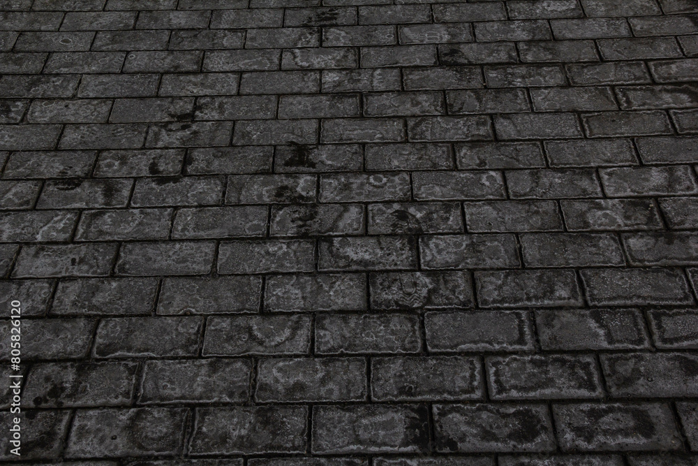 Grey paving slabs with traces of ice.