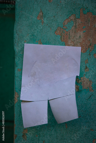 An empty ad with a tear-off part on the wall of the house.