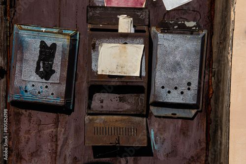 Old rusty mailboxes on the door.