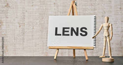 There is notebook with the word LENS. It is as an eye-catching image.