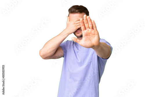 Young handsome caucasian man over isolated chroma key background making stop gesture and covering face