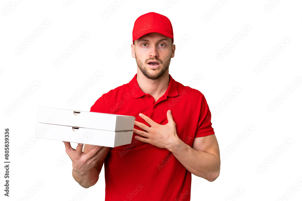 Pizza delivery man with work uniform picking up pizza boxes over isolated chroma key background surprised and shocked while looking right Pizza delivery man with work uniform picking up pizza boxes over isolated chroma key background surprised and shocked while looking right
