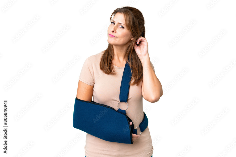Middle age with broken arm and wearing a sling over isolated background having doubts Middle age with broken arm and wearing a sling over isolated background having doubts