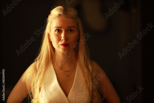 Young blonde woman at the mirror