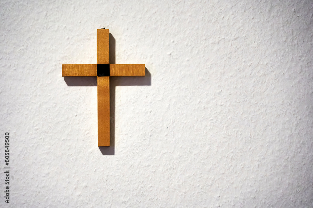 Wooden cross on a white wall