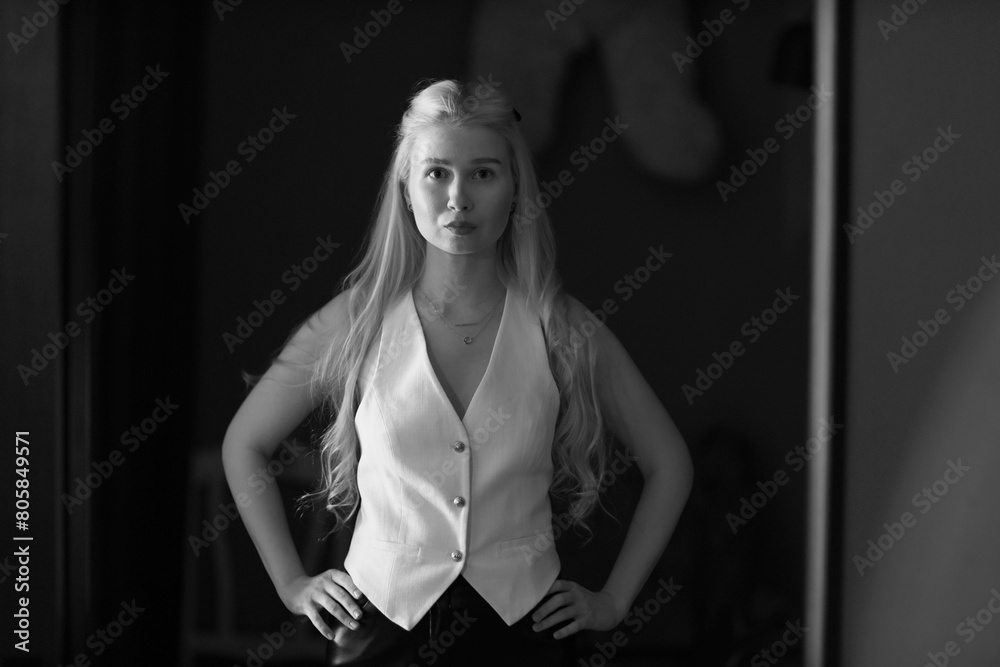 Young blonde woman in the mirror in black and white