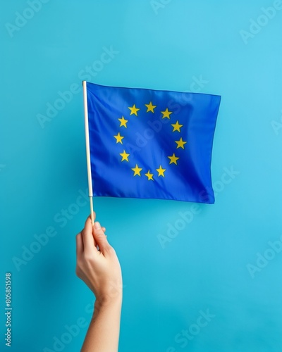 Hand Holding European Union Flag on Blue Background