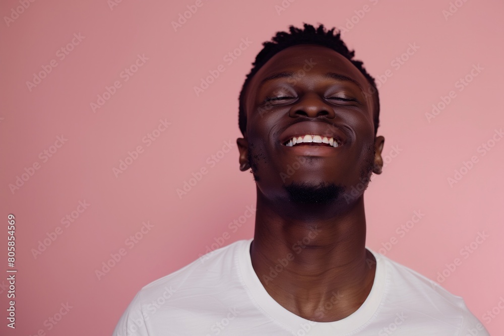 Content African American Man with Eyes Closed on Pink Background Content African American Man with Eyes Closed on Pink Background